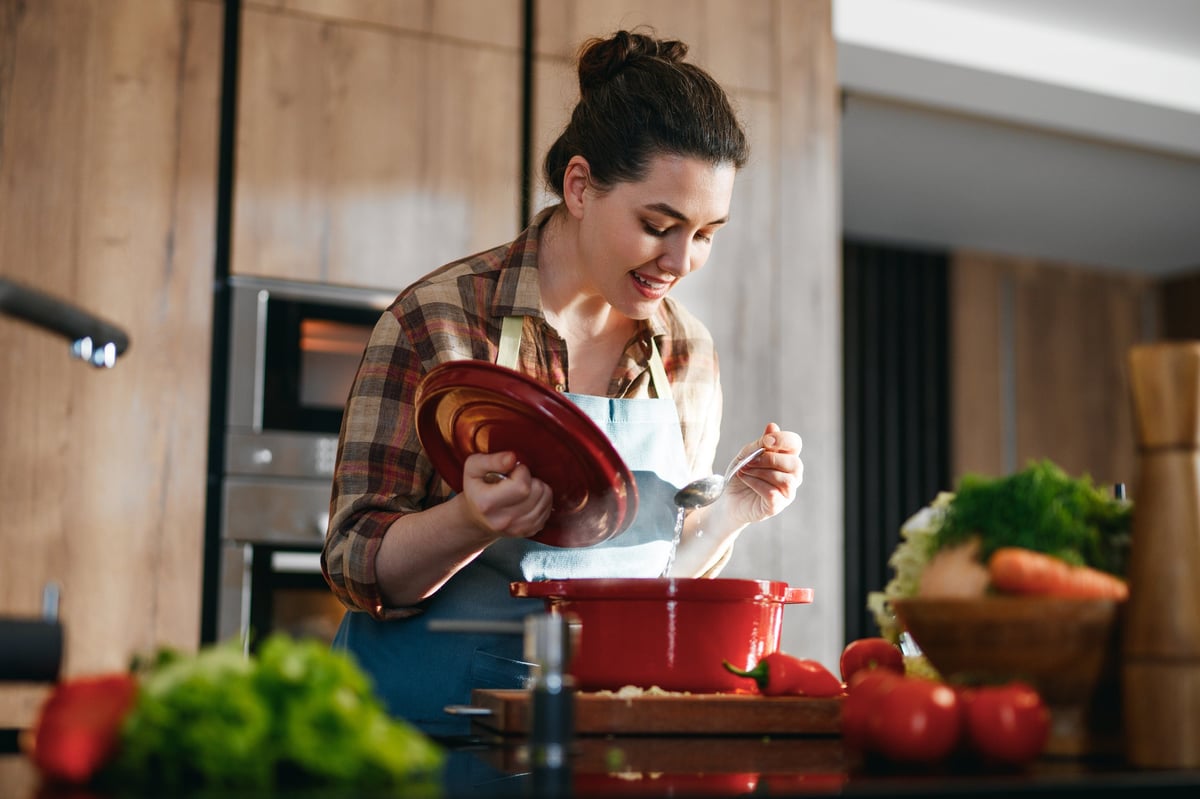 A home cook preparing fresh vegetables in a bright modern kitchen
